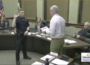 Cale Holmberg being sworn in as an Oskaloosa Police Officer by Mayor Pro Tem Bob Drost. (image from city council broadcast)